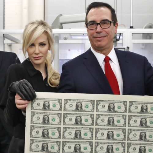  Treasury Secretary Steven Mnuchin, right, and his wife Louise Linton, hold up a sheet of new $1 bills. 