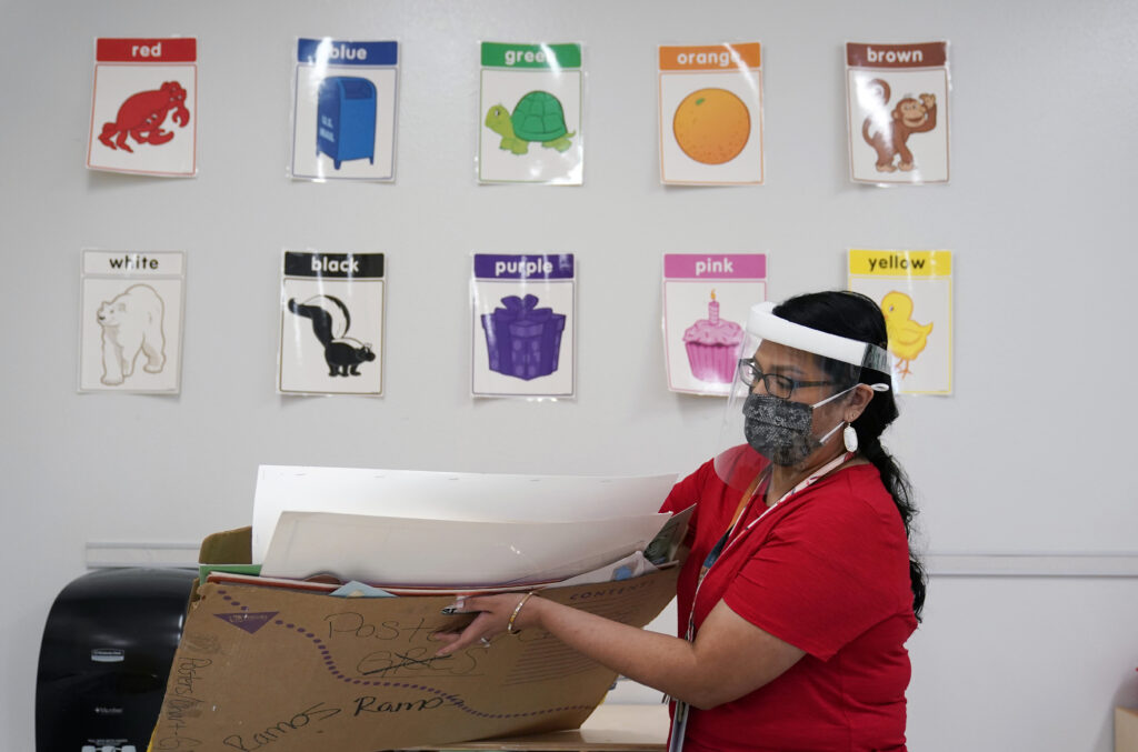 Teacher Judith Ramos wears a face mask as she prepares her classroom. The ADA requires workplaces to make reasonable arrangements that will allow workers with disabilities to do their jobs.