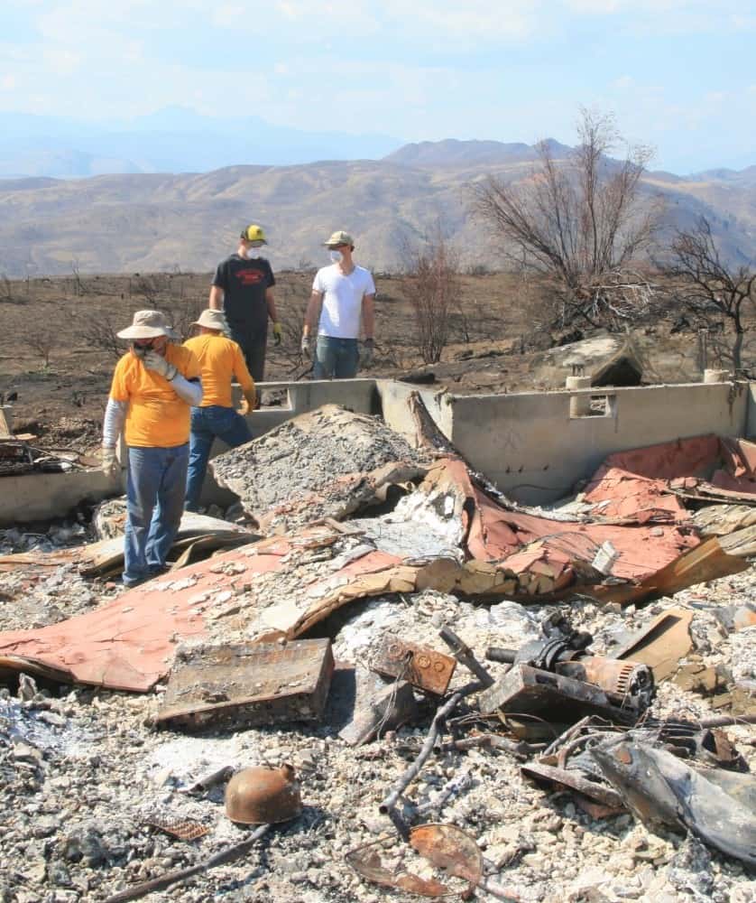 A crew of Southern Baptists from California looks for items that survived one of the wildfires in the Methow Valley, hoping to give homeowners some closure. 