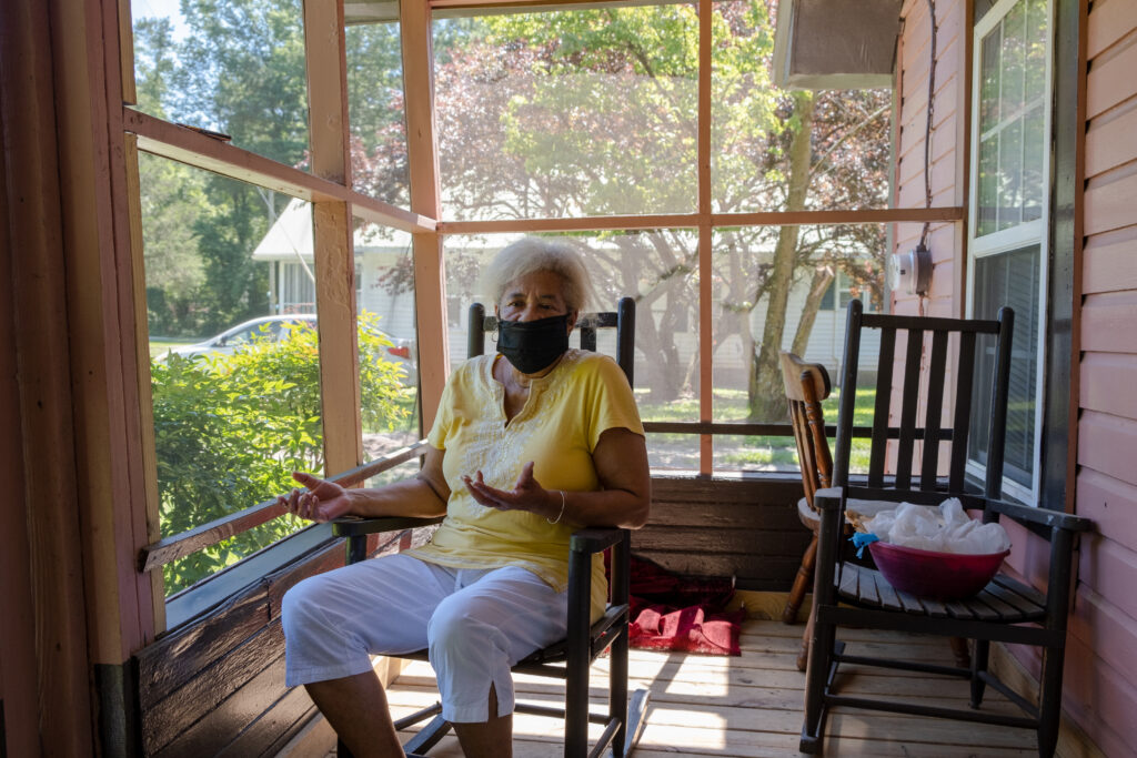 Elsie Herring sits on the porch of her home in Duplin County, N.C. Herring worries about the pollution and the smell of hog manure sprayed on a field next door. 