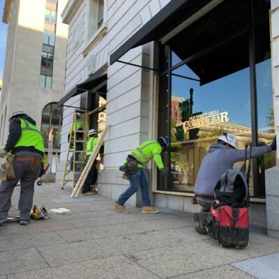 Workers board up the Old Ebbitt Grill