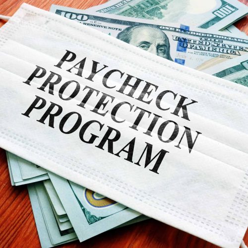  Paycheck Protection Program (PPP) written on the mask and money. 
