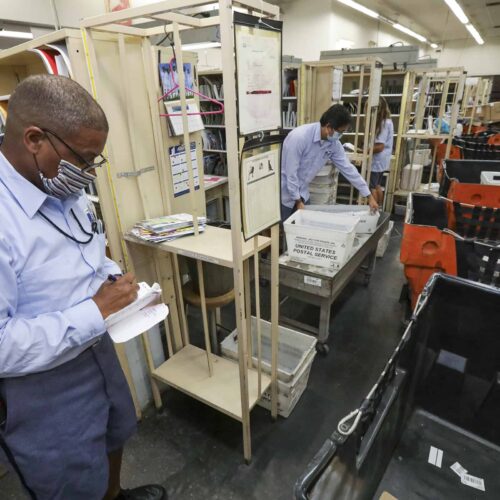  Mailman James Daniels, 59, sorts mail in his cubicle at San Clemente Post Office. 