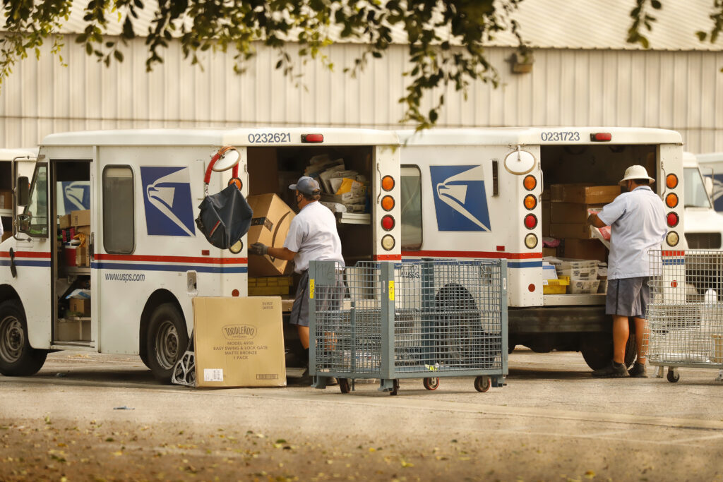 Mail carriers load their trucks at the USPS located in Van Nuys, California.