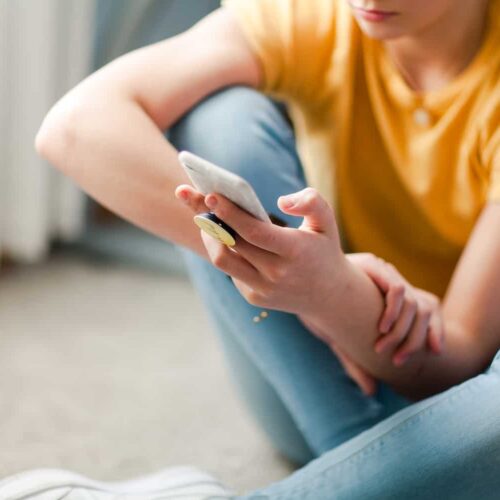  A teenager uses a cell phone to stay connected. 