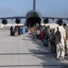 U.S. forces load passengers aboard a plane in support of the Afghanistan evacuation at Hamid Karzai International Airport.