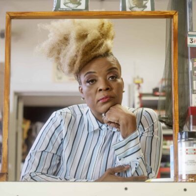 Health advocate Janell Edwards poses for a portrait inside a gas station and convenience store she owns with her husband.