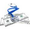 A stethoscope sits on top of $100 bills