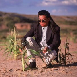 Indigenous farmer Harris Polelanema shows his stunted corn on his Hopi Reservation plot.